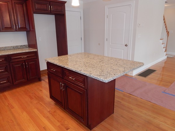 80 Locust Street Brockton, MA 02301 - Photo 8 of 20 a kitchen with stainless steel appliances granite countertop a stove a sink and a refrigerator