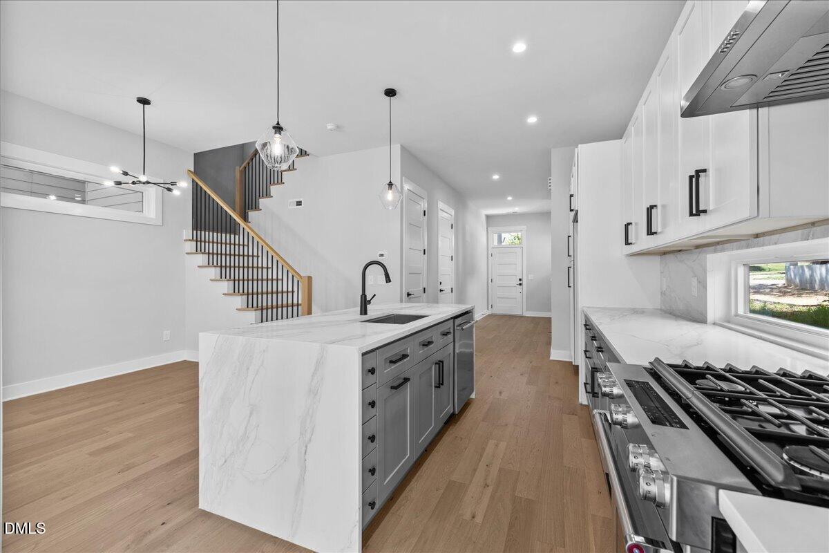 541 Bragg Street Raleigh, NC 27601 - Photo 10 of 44 a large kitchen with stainless steel appliances lots of counter space and wooden floor