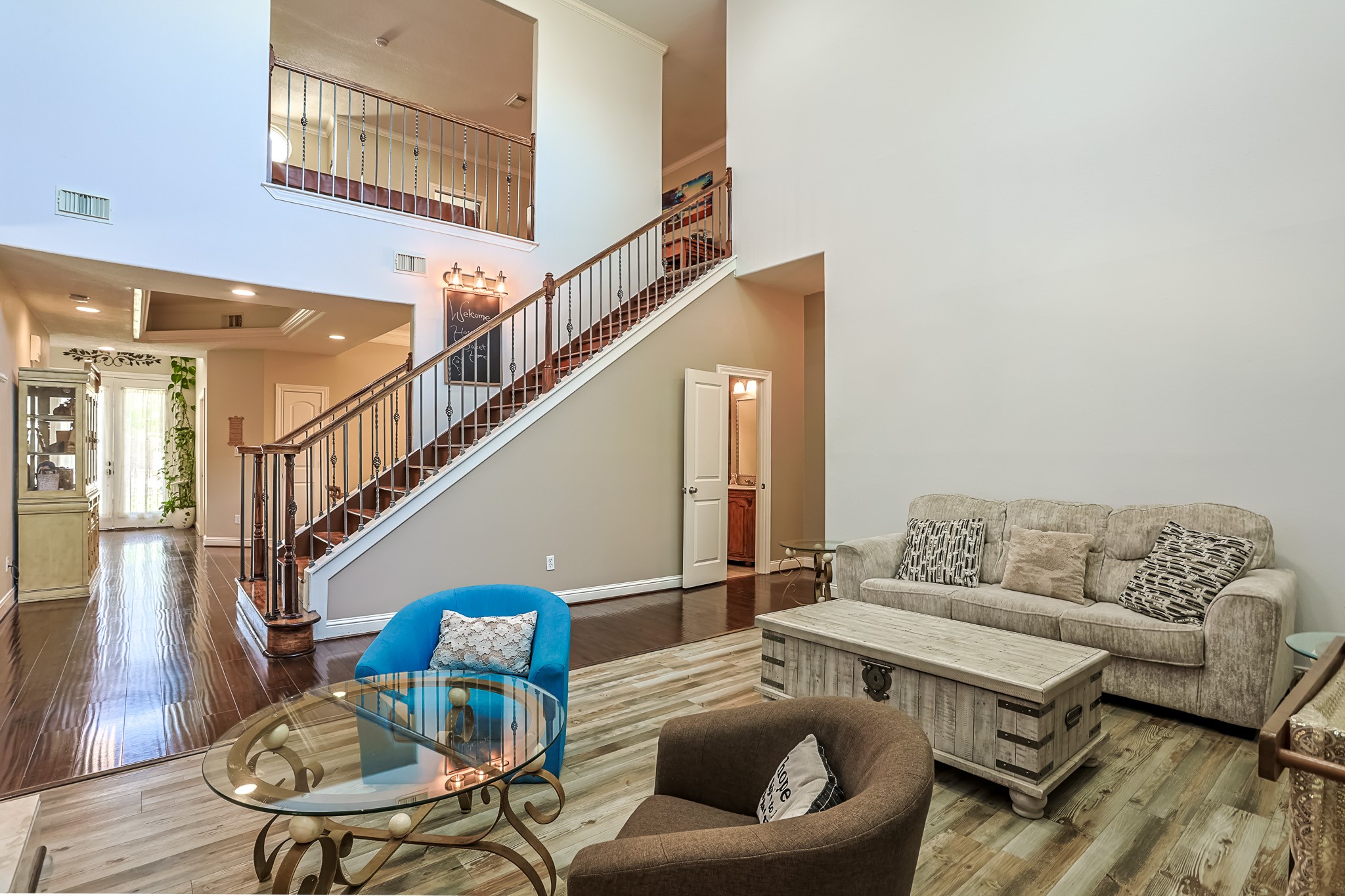 30119 West Geneva Drive Spring, TX 77386 - Photo 10 of 35 Impressive two-story living room with wrought-iron staircase and abundant natural light that highlights every elegant detail