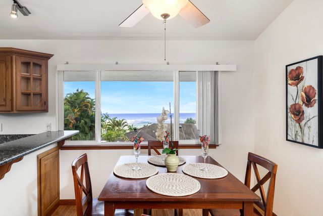 a view of a dining room with furniture and window