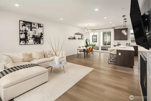 a living room with furniture wooden floor and a flat screen tv