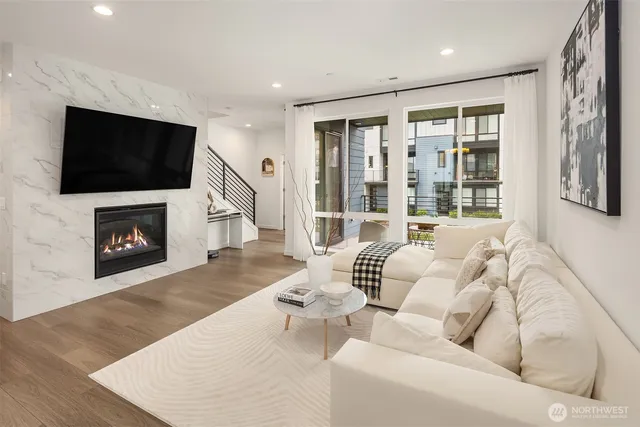 a living room with furniture tv and a fireplace