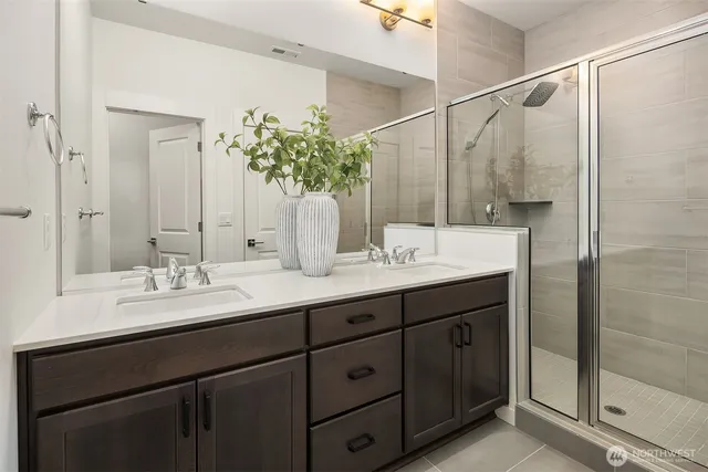 a bathroom with a double vanity sink and a mirror