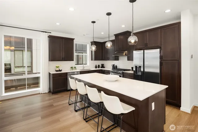 a large kitchen with a table and chairs
