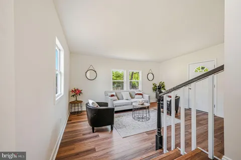 a living room with furniture window and wooden floor