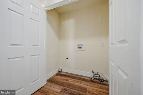 a room with a bench and wooden floor