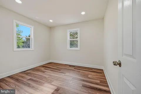 a view of a room with wooden floor and window