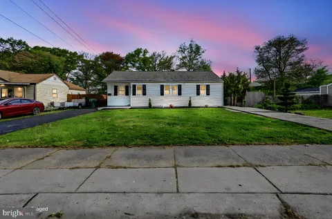 a front view of a house with a garden and yard
