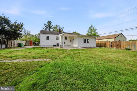 a front view of house with yard and trees