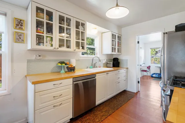 a kitchen with a refrigerator and a sink