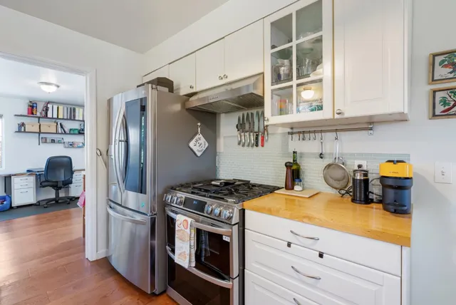 a kitchen with stainless steel appliances granite countertop a stove and a refrigerator