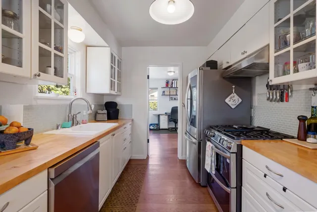 a kitchen with stainless steel appliances granite countertop a stove and a sink