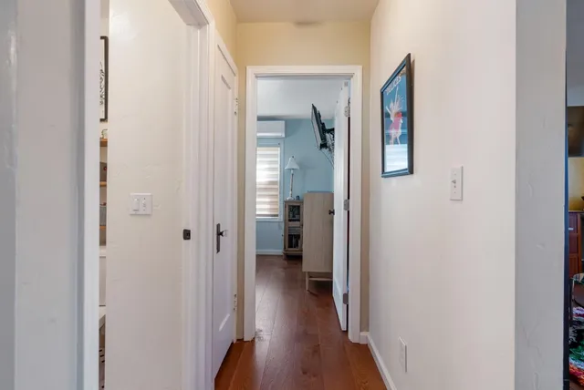 a view of a hallway with wooden floor