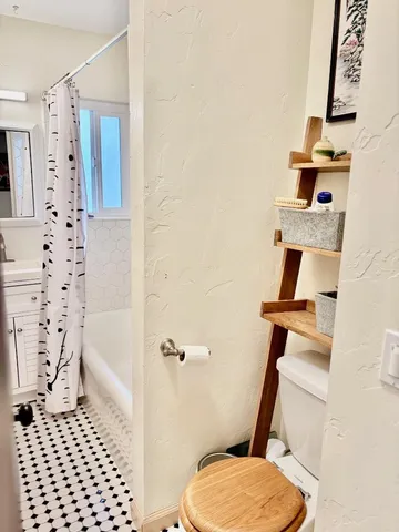 a bathroom with a toilet and a shower
