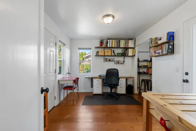 a work room with furniture and a book shelf