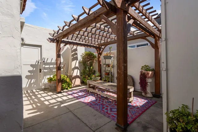 a view of a house with potted plants
