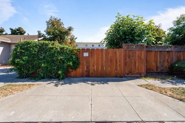 a view of a pathway gate with wooden walls