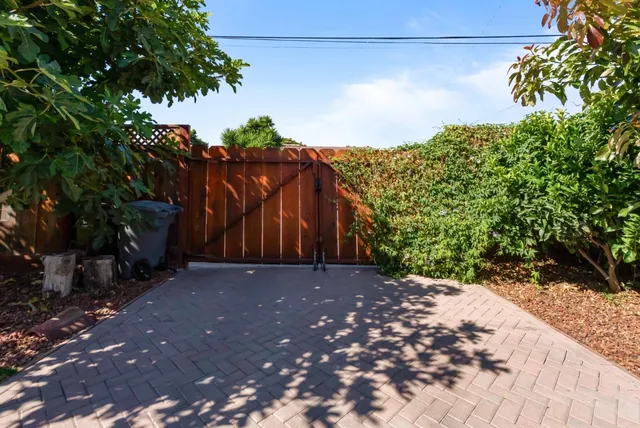 a vase of flowers sitting on a floor in front of a door