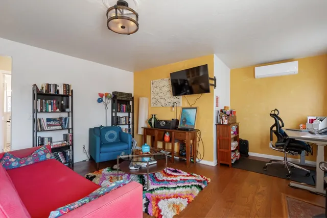 a view of a livingroom with workspace and a couch
