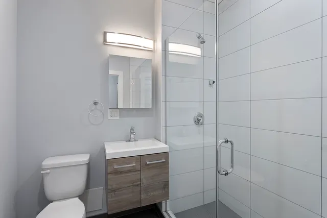 a bathroom with a toilet sink and shower