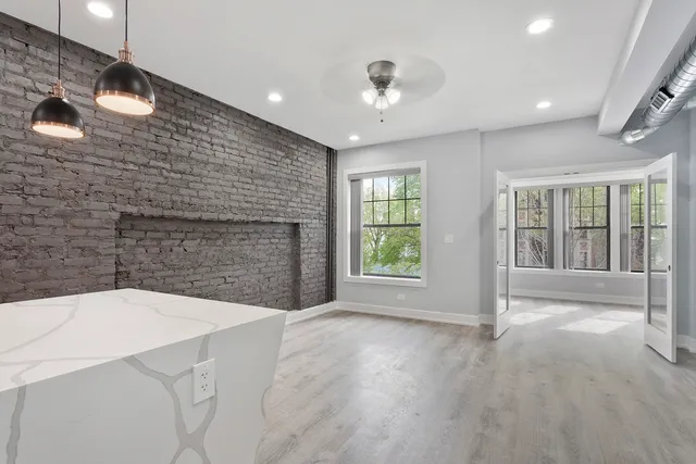 a view of an empty room with a fireplace and a window