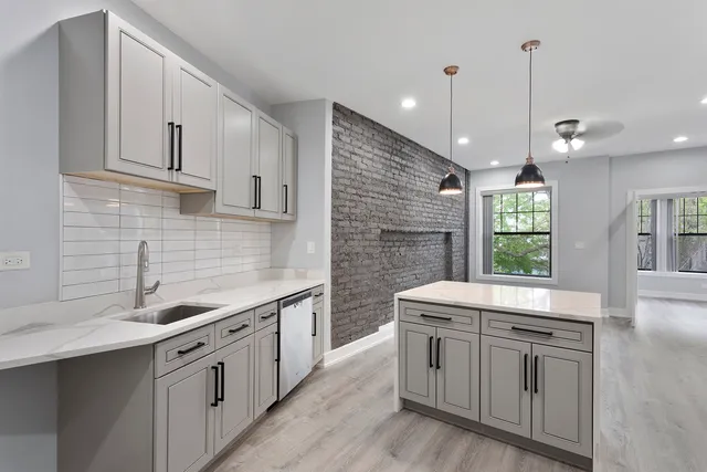 a kitchen with stainless steel appliances granite countertop a sink stove and cabinets