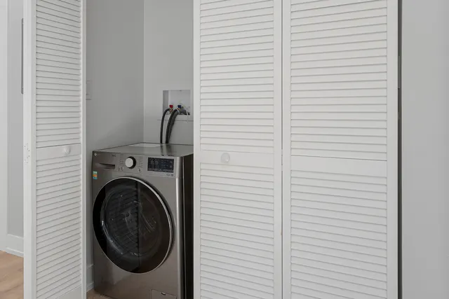a view of a hallway with washer and dryer