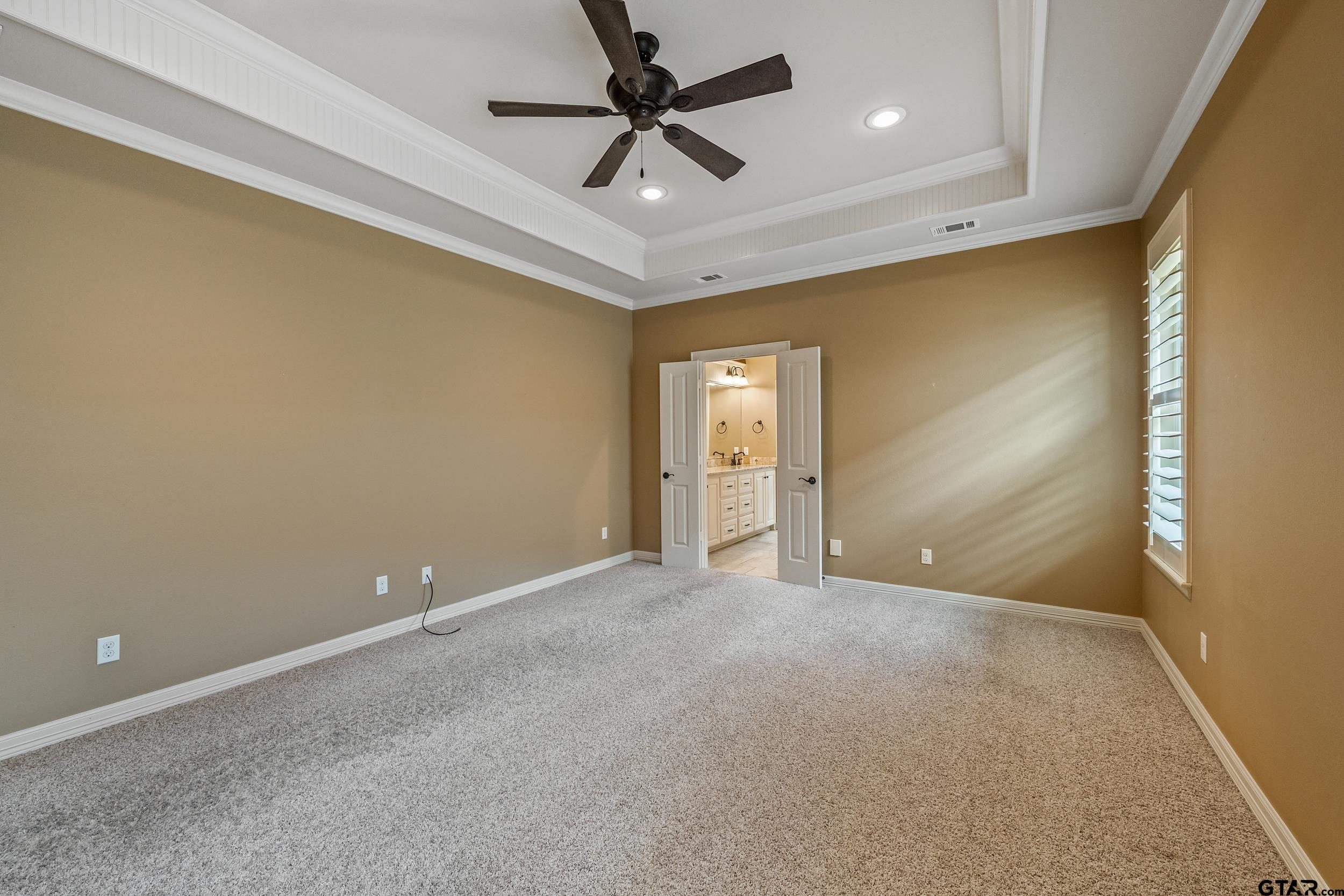 5524 Hollytree Drive Tyler, TX 75703 - Photo 15 of 27 a view of an empty room and a ceiling fan