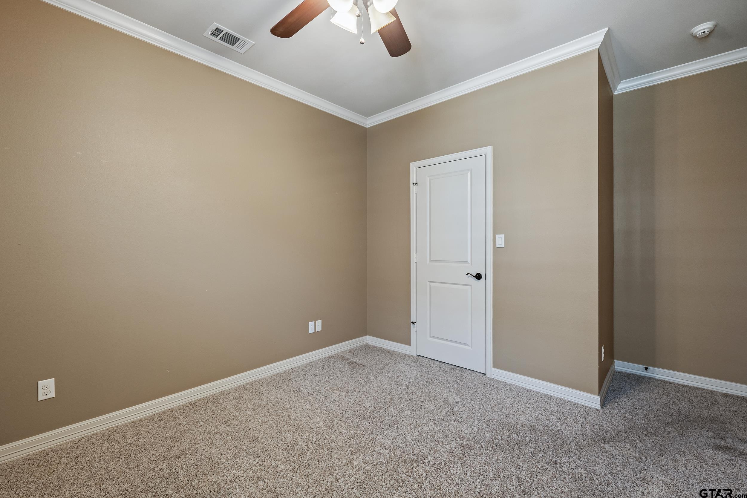 5524 Hollytree Drive Tyler, TX 75703 - Photo 23 of 27 an empty room with ceiling fan and window