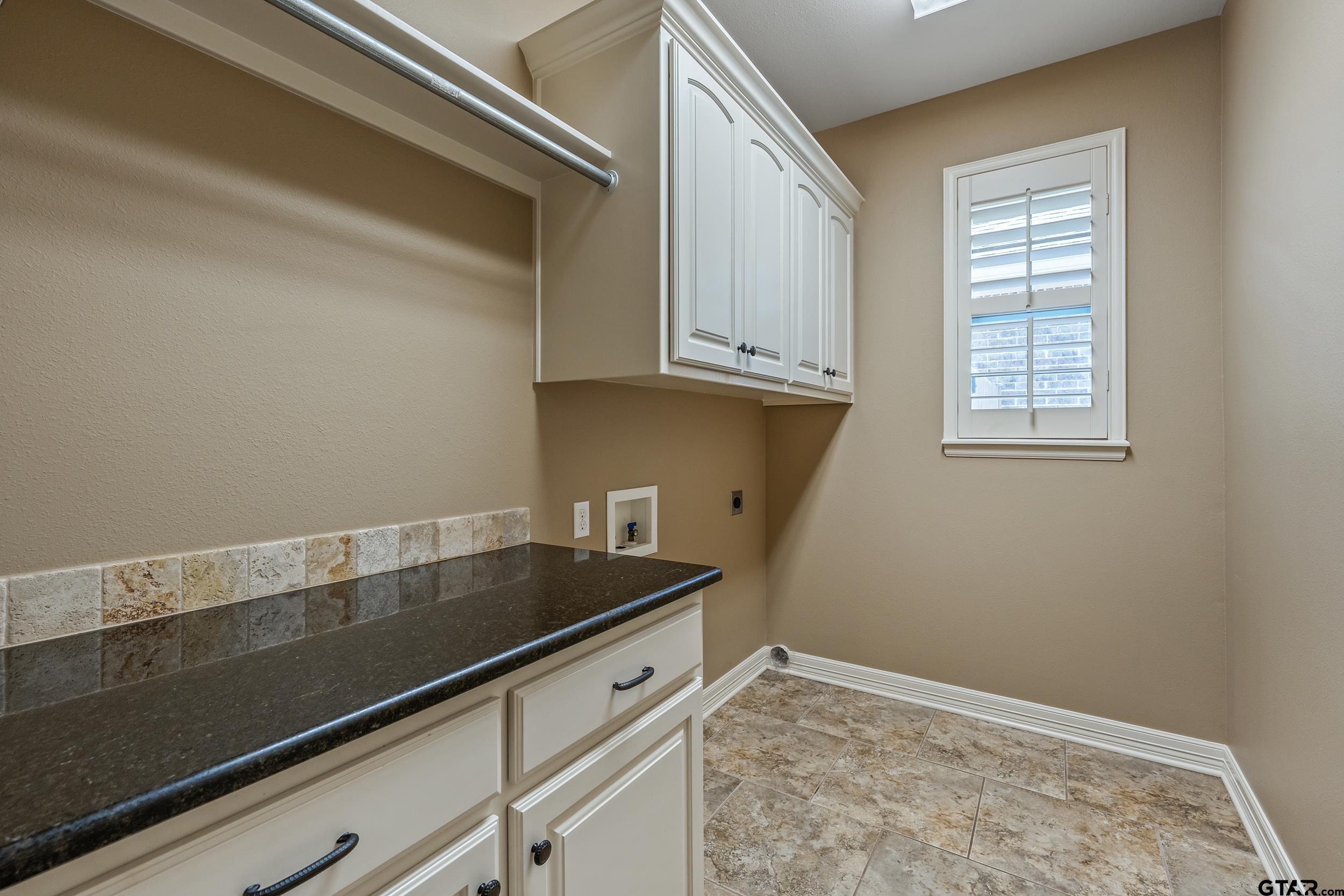 5524 Hollytree Drive Tyler, TX 75703 - Photo 24 of 27 a view of kitchen with granite countertop cabinets and window