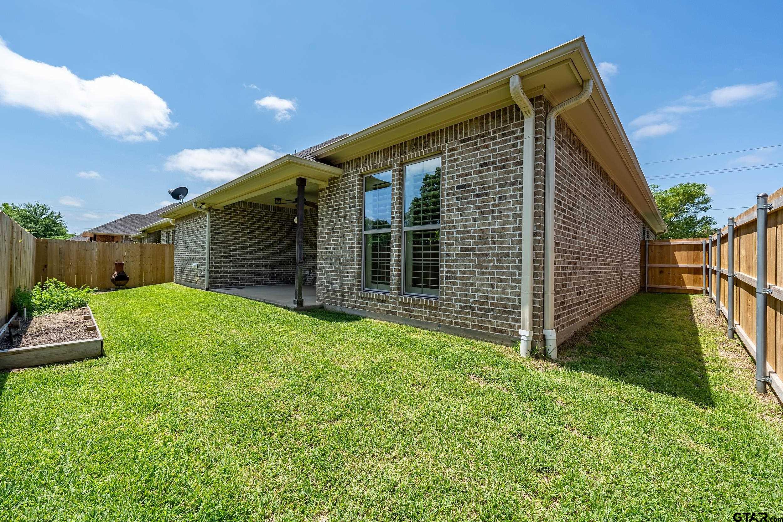 5524 Hollytree Drive Tyler, TX 75703 - Photo 27 of 27 a view of a house with backyard and garden