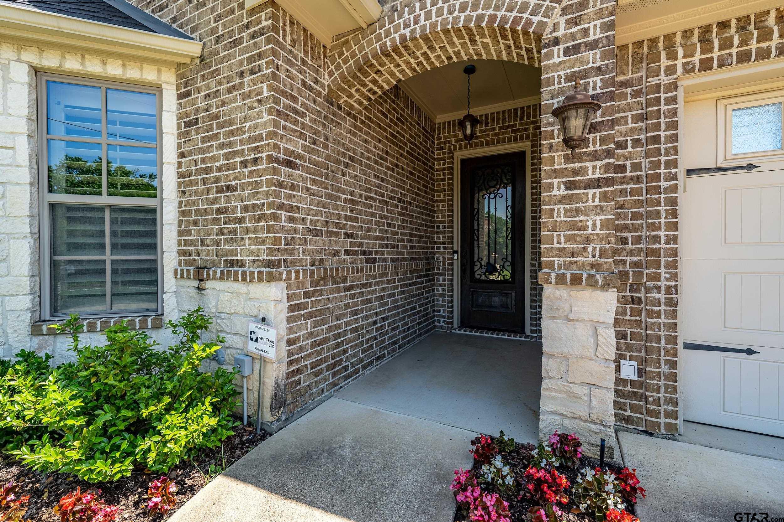 5524 Hollytree Drive Tyler, TX 75703 - Photo 4 of 27 a view of front door of house and window