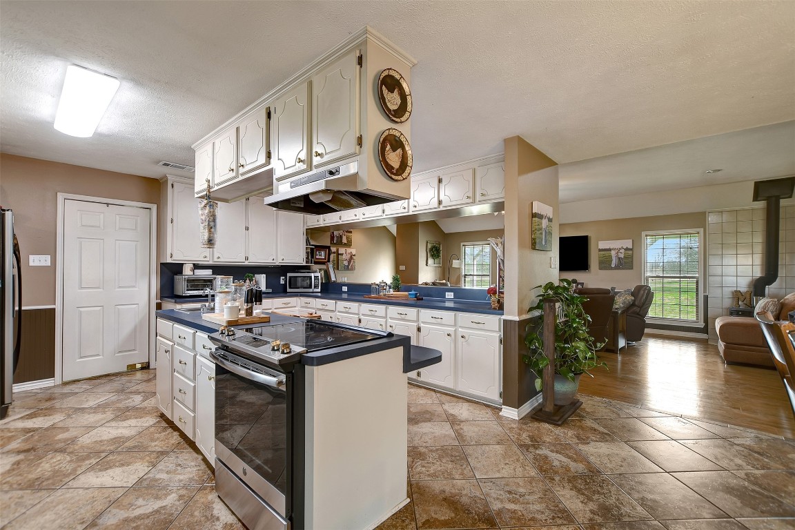 599 County Road 295 Garrison, TX 75946 - Photo 14 of 50 a kitchen with stainless steel appliances granite countertop a stove and a sink