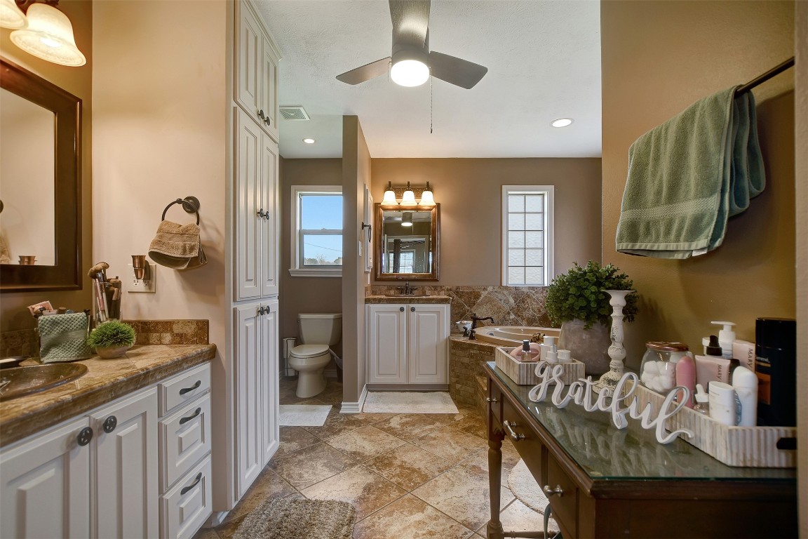 599 County Road 295 Garrison, TX 75946 - Photo 22 of 50 a spacious bathroom with a granite countertop sink a mirror and shower