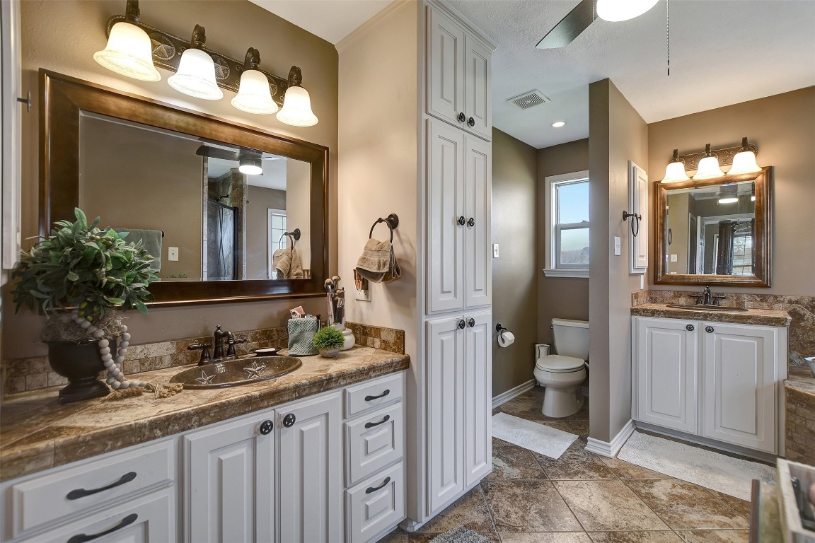 599 County Road 295 Garrison, TX 75946 - Photo 23 of 50 a bathroom with a granite countertop sink mirror and a toilet