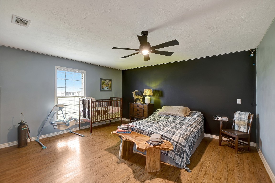 599 County Road 295 Garrison, TX 75946 - Photo 26 of 50 a bedroom with a bed and wooden floor