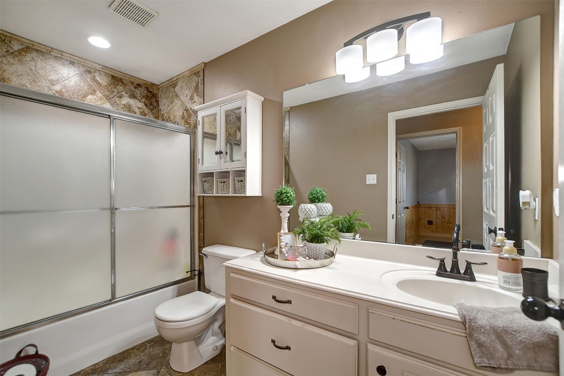 599 County Road 295 Garrison, TX 75946 - Photo 29 of 50 a bathroom with a toilet a sink and mirror