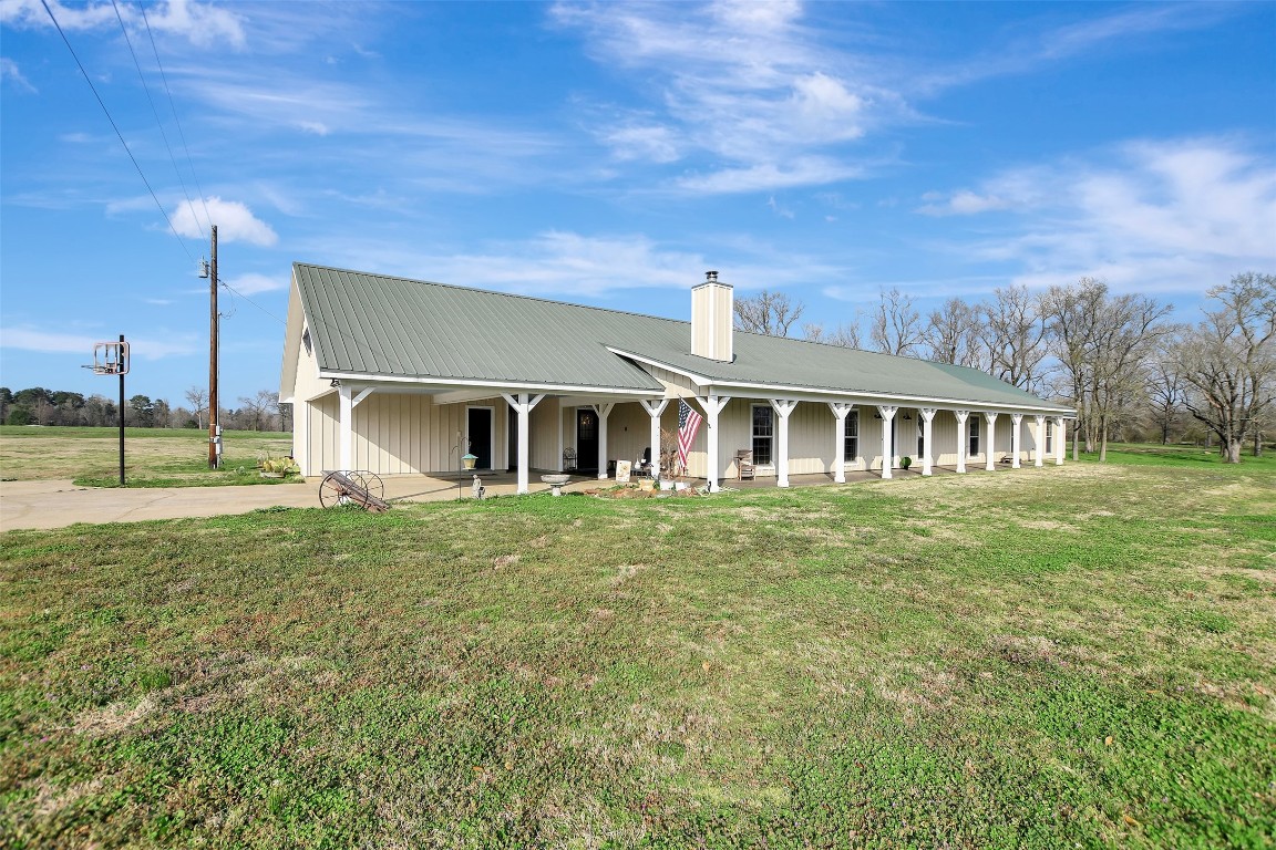 599 County Road 295 Garrison, TX 75946 - Photo 5 of 50 a front view of a house with a garden