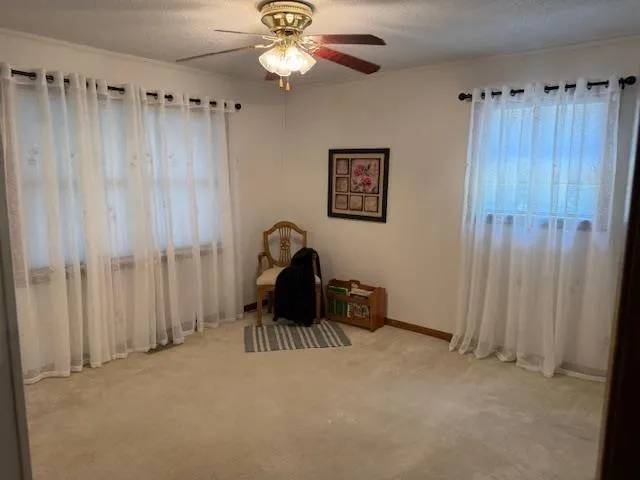 a view of a room with a hanging light and a window