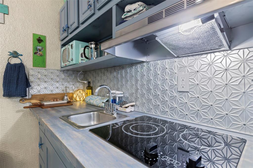 16333 Gulf Boulevard, Unit 113 Redington Beach, FL 33708 - Photo 8 of 40 a kitchen with a sink stove and cabinets