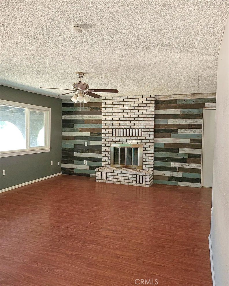 23080 Clement Street Red Bluff, CA 96080 - Photo 3 of 11 a view of an empty room with a fireplace and a window