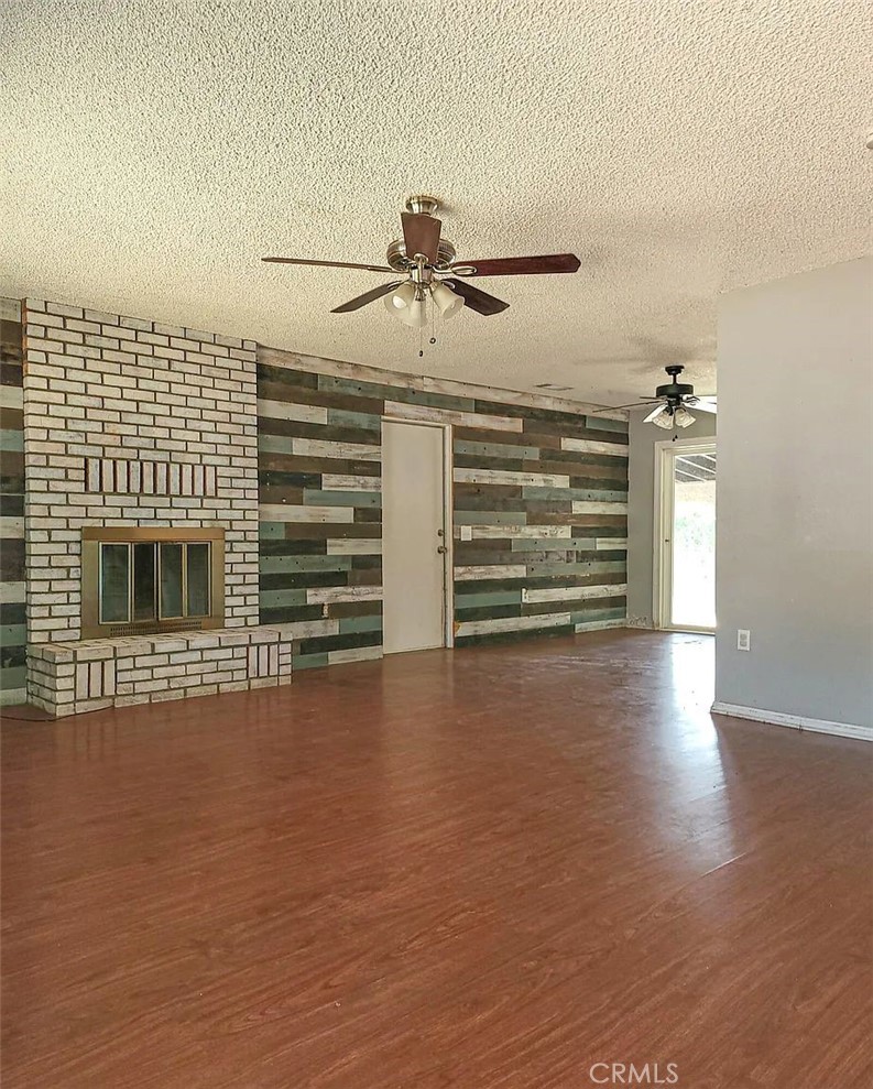 23080 Clement Street Red Bluff, CA 96080 - Photo 4 of 11 a view of a livingroom with a fireplace wooden floor and windows