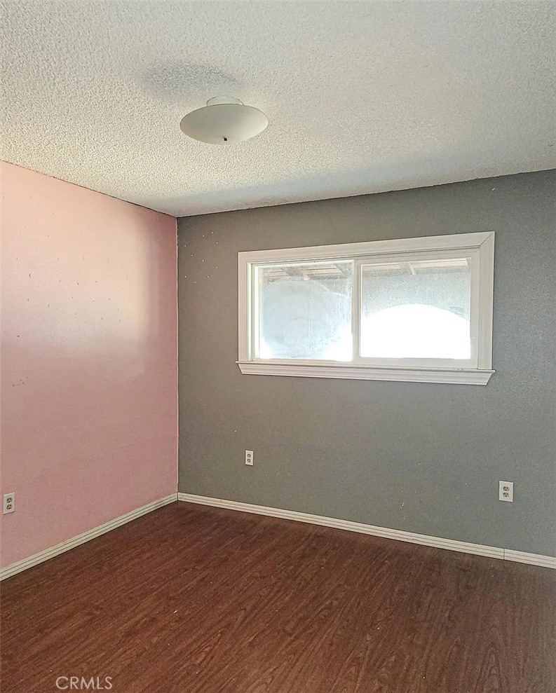 23080 Clement Street Red Bluff, CA 96080 - Photo 9 of 11 an empty room with wooden floor and windows