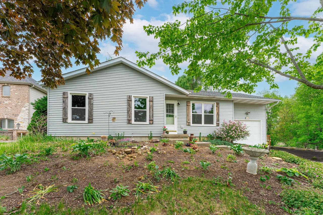 1084 Winborne Road Lake Summerset, IL 61019 - Photo 1 of 27 a house with lots of trees in the background