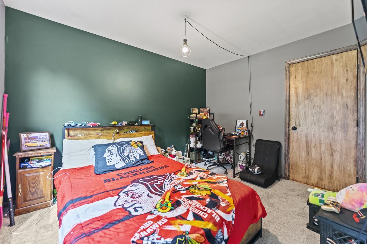 1084 Winborne Road Lake Summerset, IL 61019 - Photo 13 of 27 a bedroom with a bed a table and chair