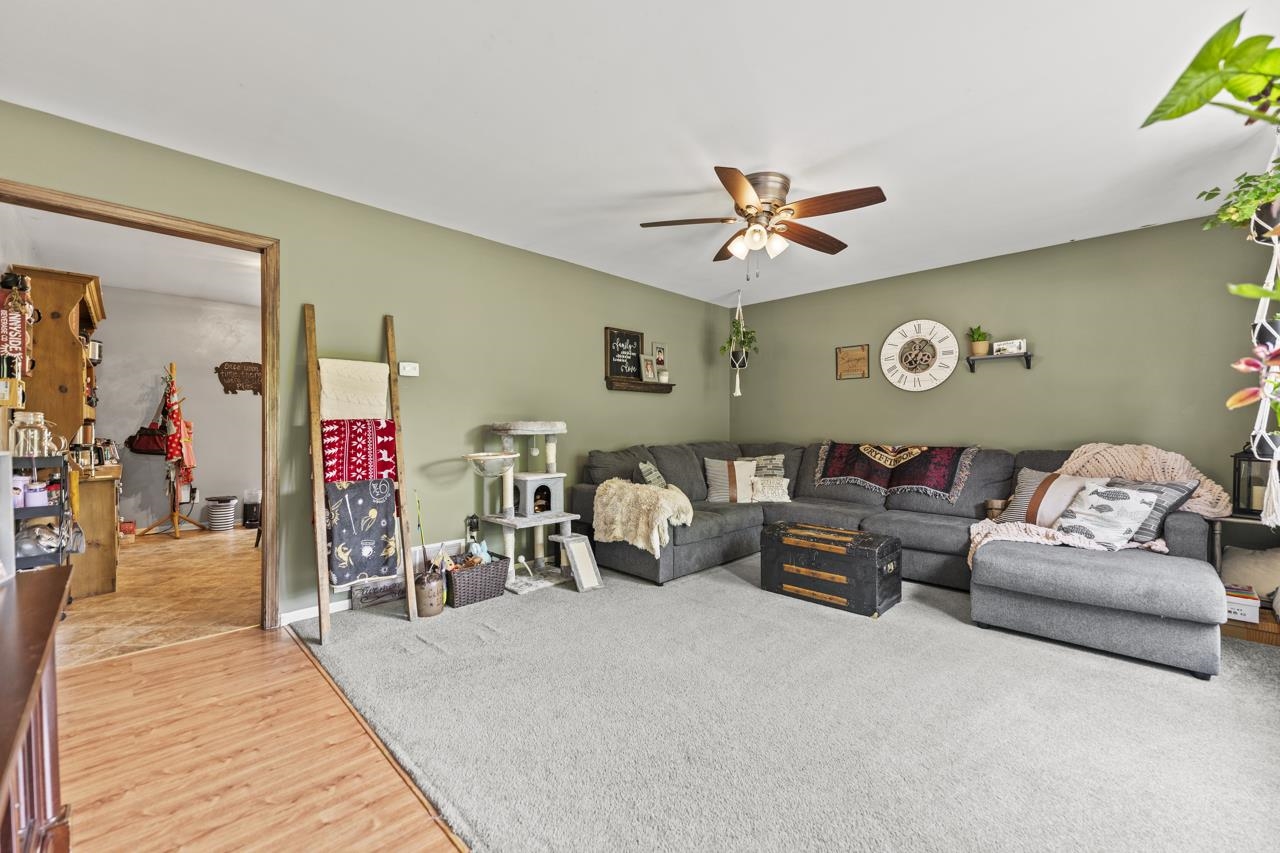 1084 Winborne Road Lake Summerset, IL 61019 - Photo 4 of 27 a living room with furniture and a chandelier