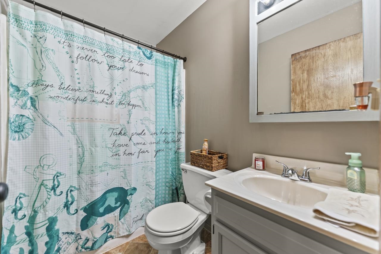1084 Winborne Road Lake Summerset, IL 61019 - Photo 8 of 27 a bathroom with a sink a toilet and shower curtain