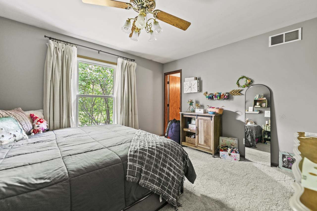 1084 Winborne Road Lake Summerset, IL 61019 - Photo 10 of 27 a bedroom with a bed and a chandelier