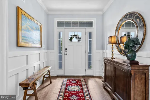 a kitchen with stainless steel appliances kitchen island granite countertop a stove a sink a dining table and chairs with wooden floor