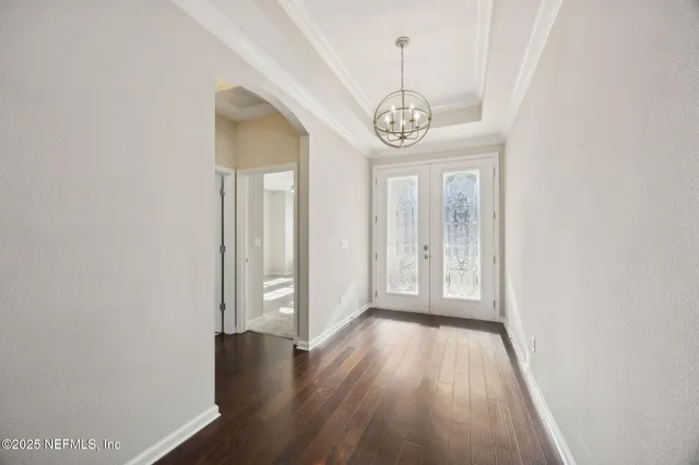 a view of a dining room with furniture wooden floor and a chandelier